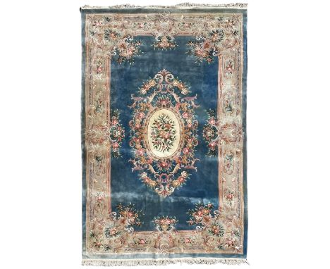 Large Chinese blue ground woollen carpet, overall floral design, central oval medallion surrounded by scrolling floral decora