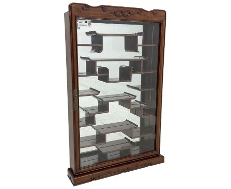 Chinese hardwood wall hanging curio cabinet, the mirror interior fitted with stepped shelves, enclosed by single glazed doors