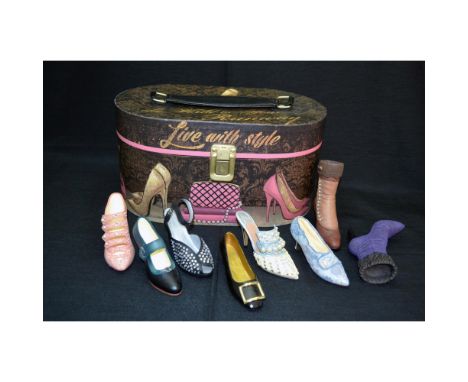 A 9 Piece Collection featuring a Vintage Travelers Fashion Shoe Suitcase, oval shaped with gold toned hinges, top strap and o