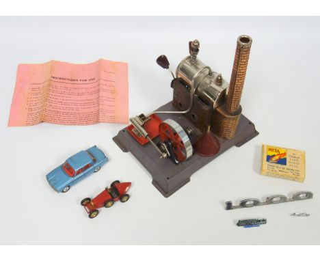 German Wilesco tinplate stationary live steam engine with fire box, chimney and funnel, on a plinth base, with instructions, 