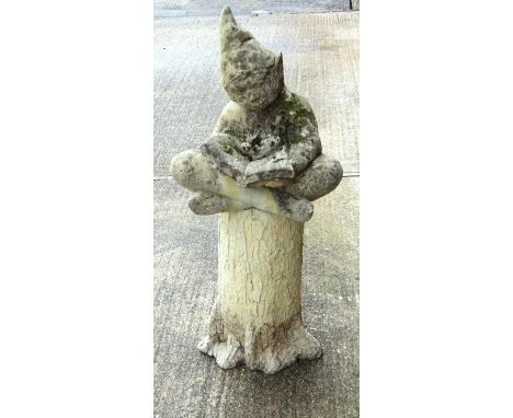 Composition figure of a gnome, sitting crossed legged reading a book, on a composition tree trunk base, H 100cm (2) 