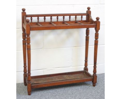 Edwardian oak stick stand with a spindle back, 10 divisions and metal drip pan, on turned tapering columns, W 71.2cm 