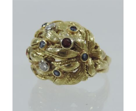 An 18 carat gold ruby, diamond and sapphire ladies ring