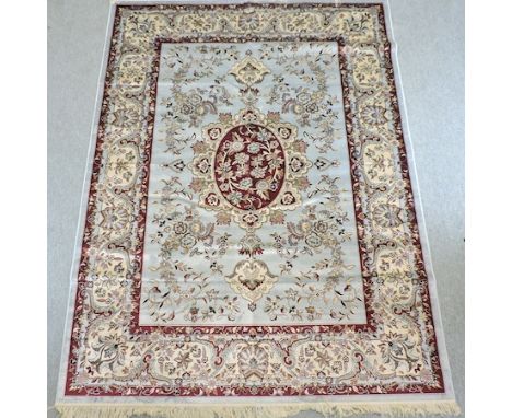 A Keshan carpet, with floral designs on a blue ground, 280 x 200cm