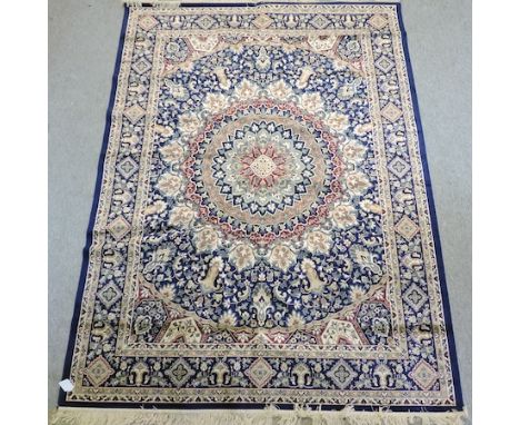 A Keshan carpet, with a central medallion, on a blue ground, 280 x 200cm