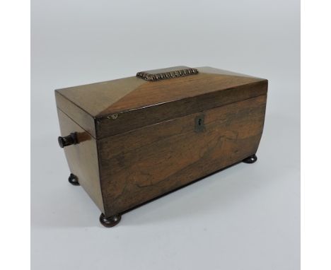 A late Regency rosewood tea caddy, of sarcophagus shape, on bun feet, 34cm