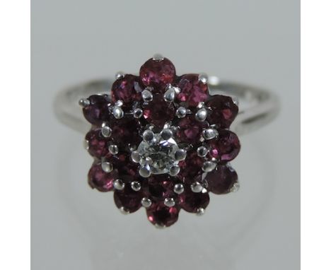 An 18 carat white gold ruby and diamond cluster ring