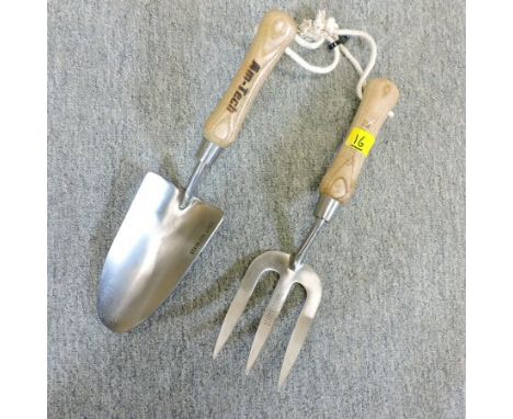 A stainless steel hand trowel and fork