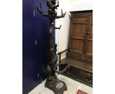 A Black Forest carved wooden and stained stick stand as a mother bear with bear cub above her in tree branches