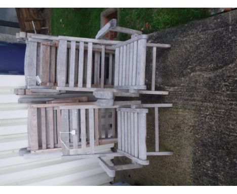 Seven folding teak garden chairs