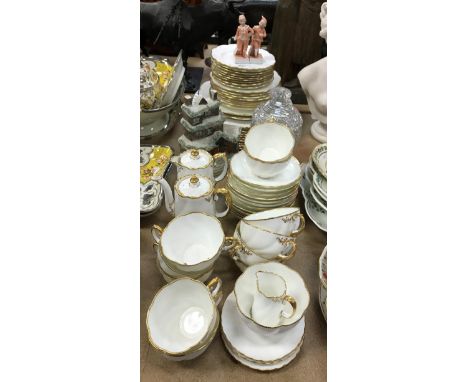 An Aynsley gilt decorated dinner/tea set together with a Staffordshire type flat back model of a house and two Continental Fa