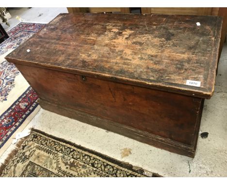 A Victorian stained pine trunk with wrought iron side carrying handles