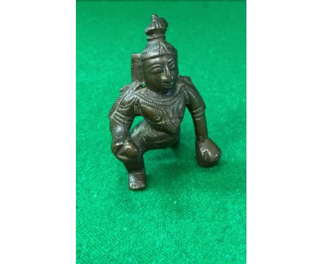 A Chola bronze figure of baby Krishna crawling with a butter ball in hand