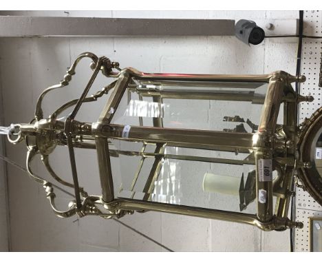 A modern brass and glass hall light of rectagonal form with six bevel plates