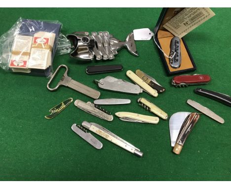 A collection of twelve pocket knives together with a Wenger penknife, a collection of corkscrews and bottle openers, a set of