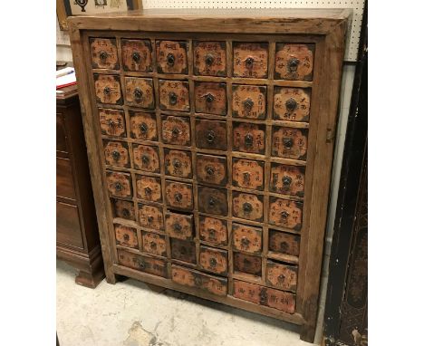 An Oriental elm chest of forty-five drawers each with script embellished paper labels and ring handles CONDITION REPORTS Has 