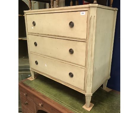 A painted commode chest of three drawers in the Louis XVIth manner