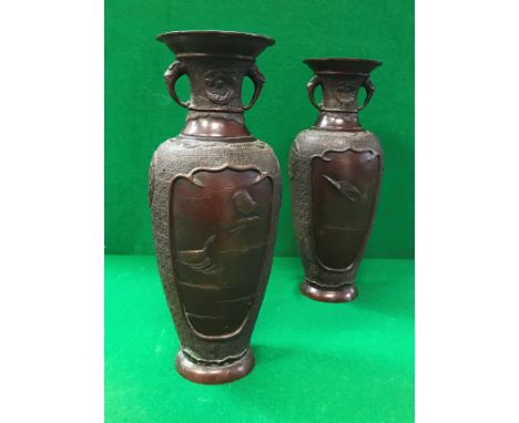 A pair of 19th Century Japanese chocolate patinated bronze vases with relief work decoration of panels of birds  CONDITION RE