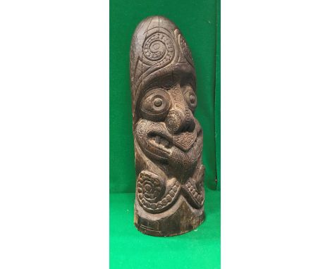 A 20th Century Polynesian style carved hard wood Tiki post head with tattooed face grimacing with tongue protruding CONDITION