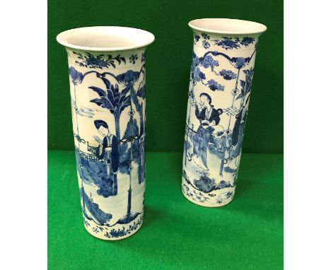 A pair of 19th Century Chinese blue and white cylindrical vases with flared rims, decorated with figures in a garden setting,