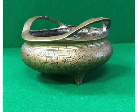 A 19th Century Chinese bronze censer with all over decoration of four toed dragons raised on three foliate decorated feet bea
