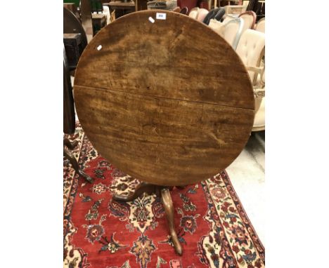 A circa 1800 mahogany tea table, the circular snap top on a baluster turned pedestal to cabriole tripod base and pad feet