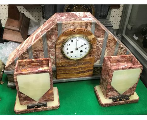 An early 20th Century marble mantel clock with garniture in the Art Deco manner, the enamel dial set with Arabic numerals