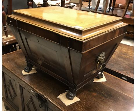 A 19th Century Irish mahogany wine cooler of sarcophagus form, the hinged lid opening to reveal a lead lined fitted interior,