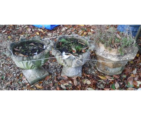 A pair of reconstituted stone garden urns and an octagonal garden urn