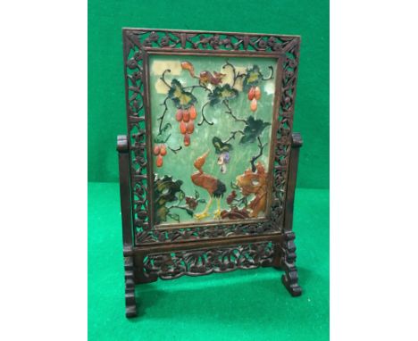 An early 20th Century Chinese jade and hardstone table screen decorated with squirrel upon a tree with stork looking on withi