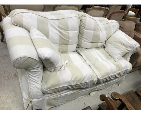 A modern upholstered scroll arm sofa with striped upholstery