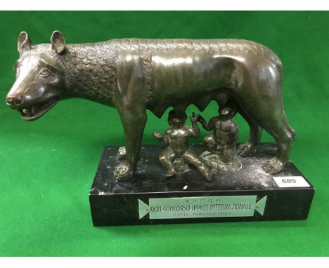 A bronze study "The Capitoline Wolf" - mythical she-wolf suckling Romulus and Remus, with patinated finish raised on a marble