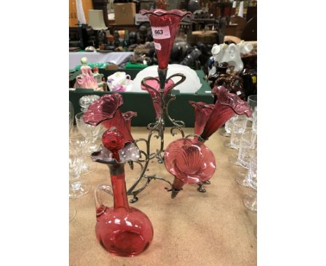 A cranberry glass epergne set on plated frame together with cranberry glass decanter with white metal mount