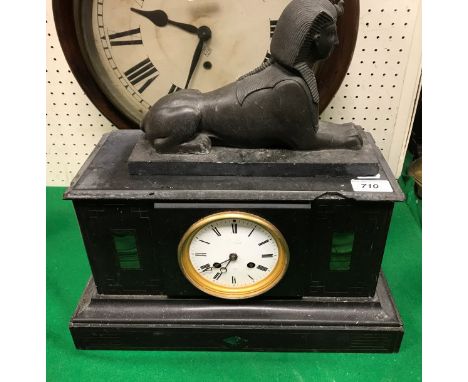 A black marble mantel clock together with a model of a sphinx and a basket of assorted stone and mineral samples etc