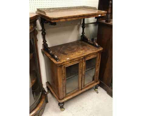 A Victorian walnut music cabinet with galleried shelf over a recess and two glazed cupboard doors