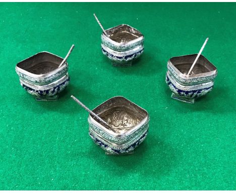 A set of four Chinese silver or white metal and blue enamel decorated salts of square form embossed with dragons together wit
