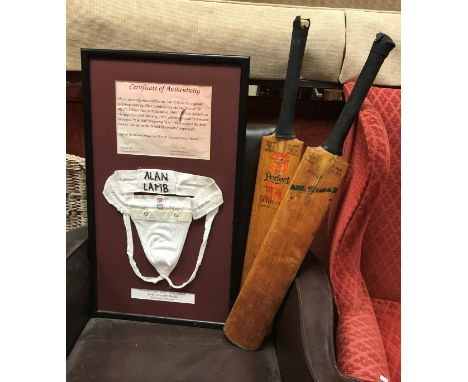 A framed jockstrap inscribed "Allan Lamb" with certificate of authenticity together with two vintage cricket bats and a Redwo
