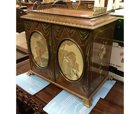 A 19th Century mahogany table top cabinet, the top with brass three quarter gallery over two doors with silkwork and painted 