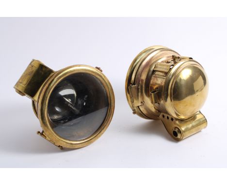 A near pair of acetylene headlamps by B & L Auto Lamp Mfg Co, New York, circa 1910,each brass body with stirrup mount, simple