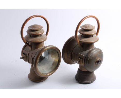 A pair of model 56 oil illuminated side lights by Attwood Mfg Co, American, circa 1908,brass, with 6 inch diameter lens (one 