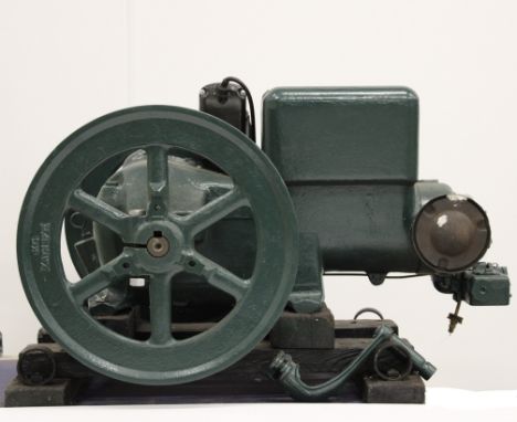 A Stationary gasoline engine,painted green, twin flywheels, crank handle, water hopper, hit and miss engine,  casing numbered