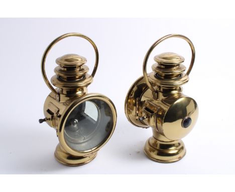 A  pair of model 819 oil illuminated sidelamps by Gray & Davis, American, circa 1910,polished brass bodies, with side flange 