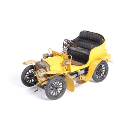 A fine scratch built model of a veteran Rolls-Royce,made in brass and wood, painted yellow (paint crazed and lifting), 9 inch