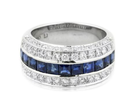 18 KARAT WHITE GOLD SAPPHIRE AND DIAMOND RING The band ring set with calibri-cut sapphires,surrounded by round-cut diamonds w