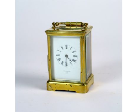A gilt brass carriage timepiece with five glass case and swing handle, platform lever escapement and white enamel dial with R