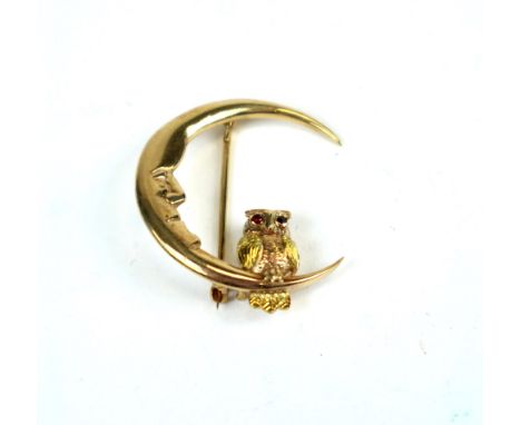 A 9ct gold owl and crescent brooch, the 'man in the moon' crescent mounted with naturallistic gold owl, with sapphire and rub