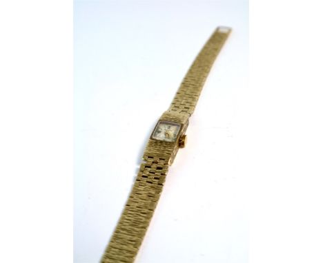 A 9ct gold Accurist ladies bracelet watch, with bark detailing on case and bracelet, silver sunburst dial with applied baton 