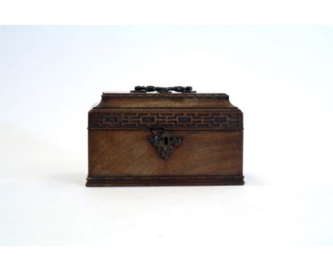 A George III mahogany tea caddy in Chippendale style with caddy top and blind fretwork frieze enclosing a vacant interior, 25