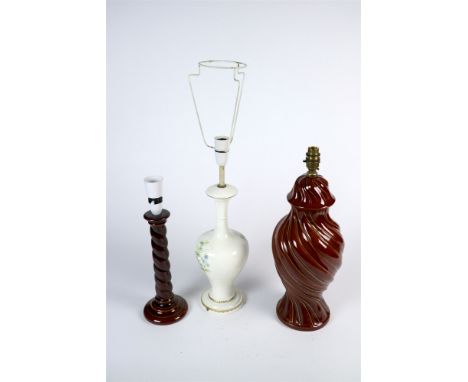 Nine brown glazed table lamp bases, including some in candlestick form, and two further table lamp bases decorated with wild 