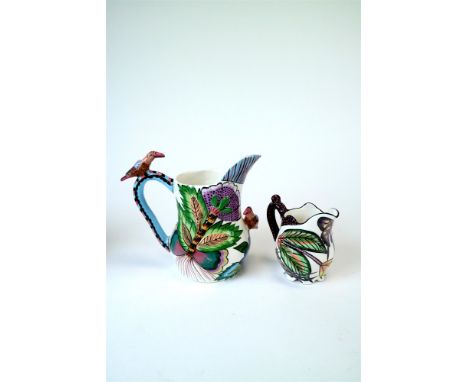 Two Ardmore studio ceramic jugs, the larger decorated with applied birds and brightly painted stylised foliage, signed ‘Matri